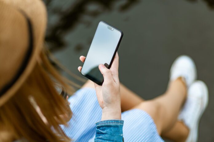 pexels-photo-1310532 person holding smartphone white sitting